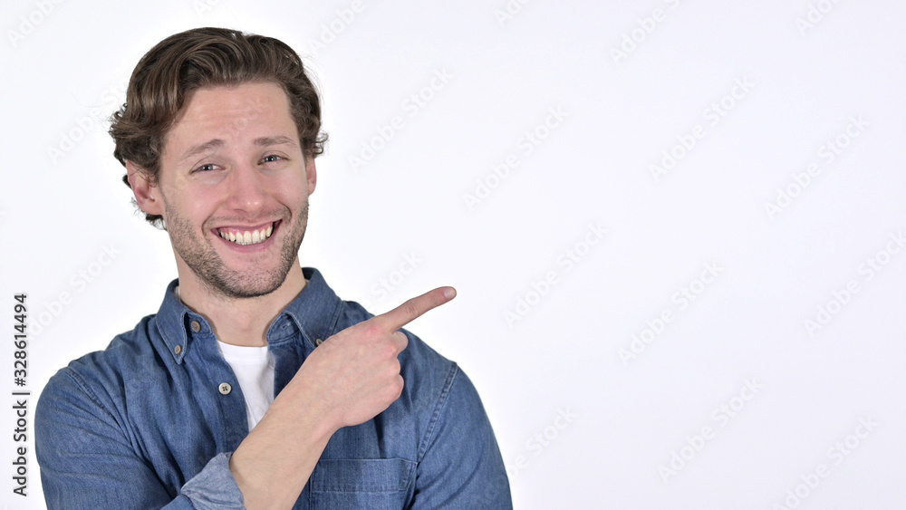 Young Man Pointing at Product, Talking on White Background Young Man Pointing at Product, Talking on White Background