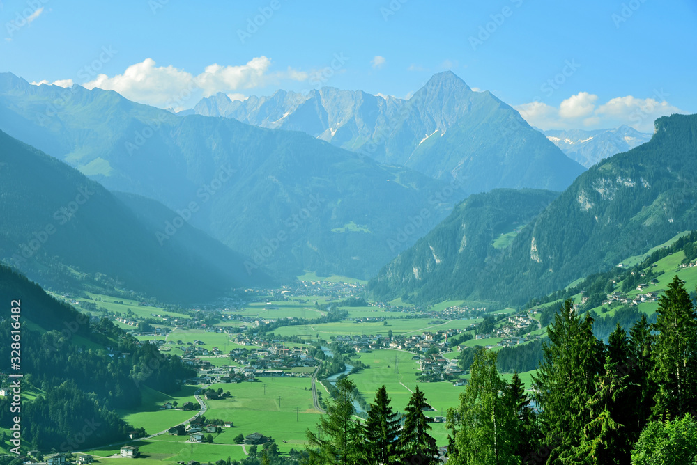 mountain and village in Tirol Austria view in the morning with fog and blue sky.