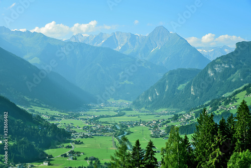 mountain and village in Tirol Austria view in the morning with fog and blue sky.