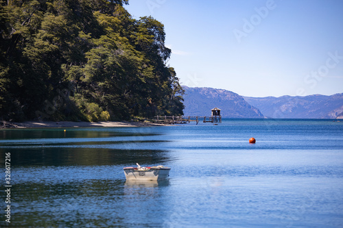 Boat and bottom pier in Bahia Mansa, Lake Nahuel Huapi, Villa la Angostura, Patagonia Argentina photo