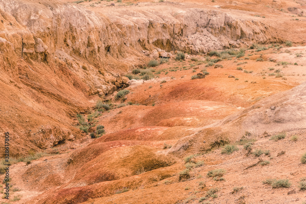 Red canyon in hills. Soil erosion following drought, climate change and formation of gullies. Lack of water in dry steppe Red canyon in hills. Soil erosion following drought, climate change and formation of gullies. Lack of water in dry steppe