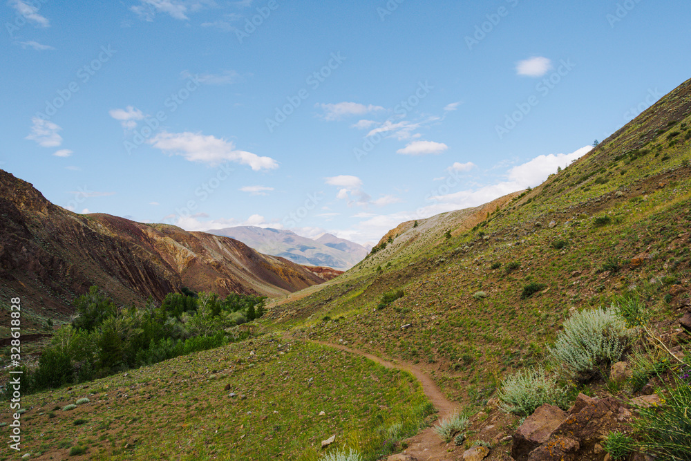 lonely stone path among trees and rocks, hiking in mountains, traveling through valley lonely stone path among trees and rocks, hiking in mountains, traveling through valley