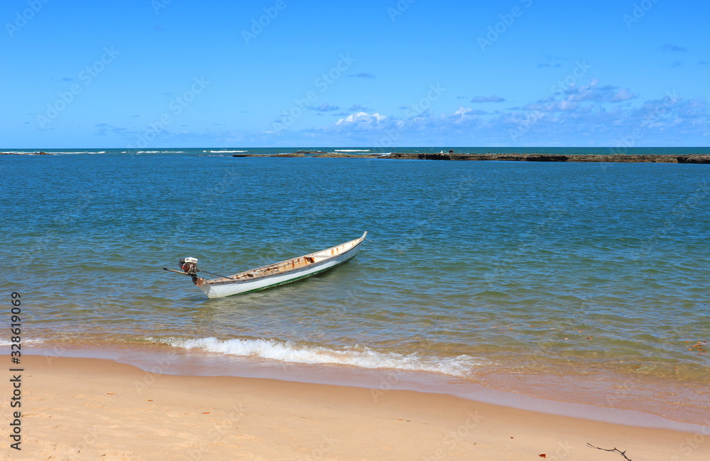 Boat is on the beautiful beach of Gunga, in the city of Roteiro, state of Alagoas, Brazil. Boat is on the beautiful beach of Gunga, in the city of Roteiro, state of Alagoas, Brazil.