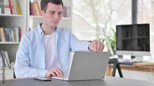 Young Man Opening Laptop for Work