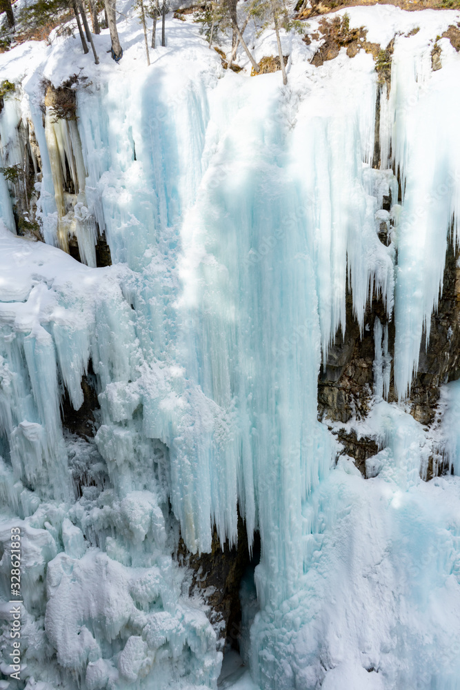 Frozen upper falls at Johnston Canyon Trail in winter, icy waterfalls landscape view. Banff National Park, Alberta, Canada Frozen upper falls at Johnston Canyon Trail in winter, icy waterfalls landscape view. Banff National Park, Alberta, Canada