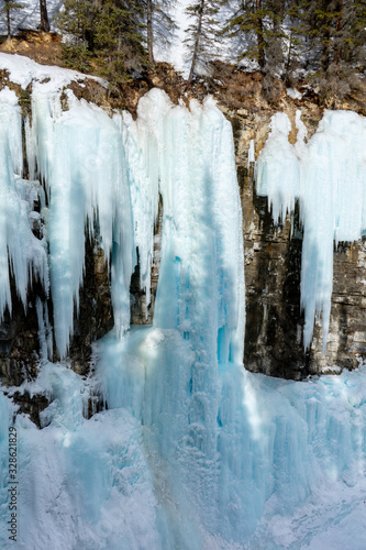 Frozen upper falls at Johnston Canyon Trail in winter, icy waterfalls landscape view. Banff National Park, Alberta, Canada © Dajahof