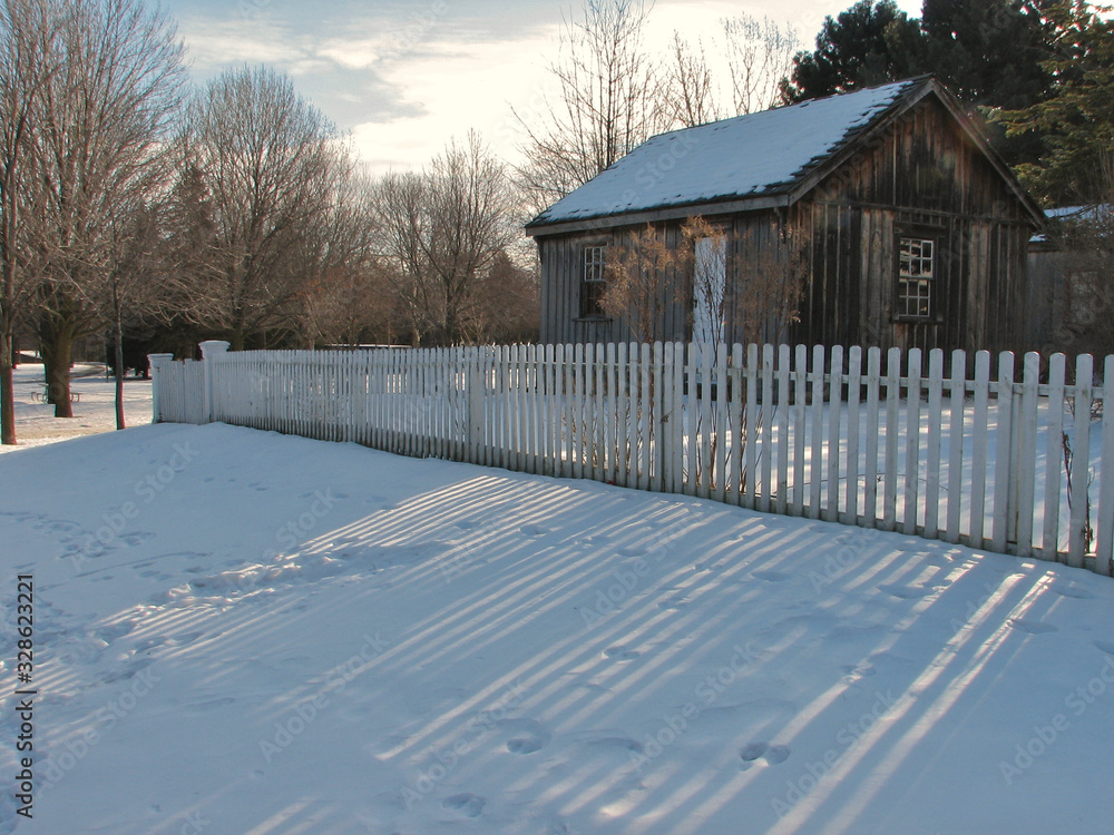 house exterior with white picket fence in winter. Scarbourgh, Ontario, Canada.