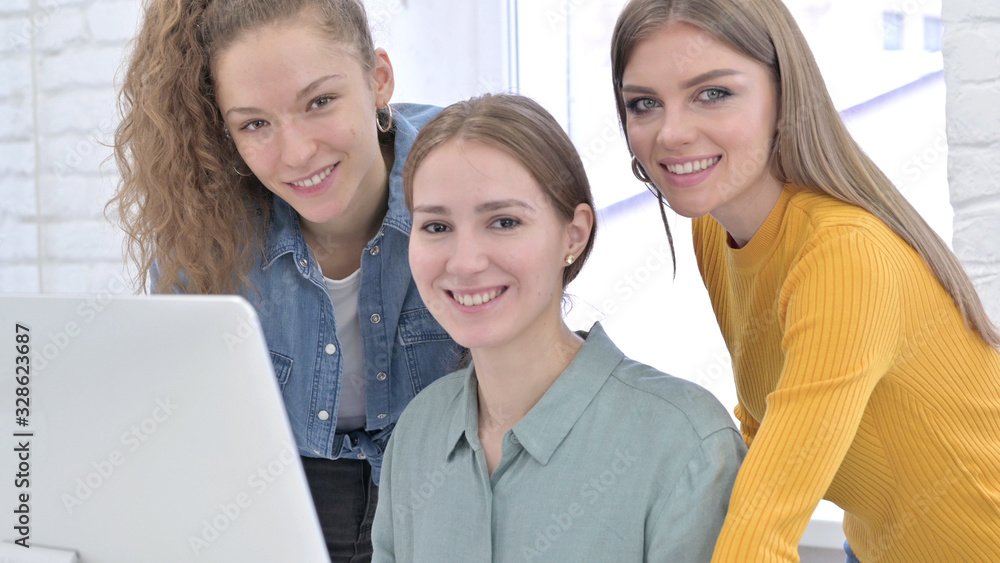 Happy Creative Designers Looking at the Camera and Smiling Happy Creative Designers Looking at the Camera and Smiling