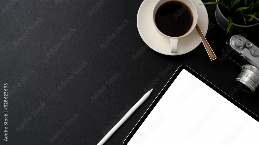 Top view of photographer workspace with blank screen tablet, camera, coffee cup and copy space Top view of photographer workspace with blank screen tablet, camera, coffee cup and copy space