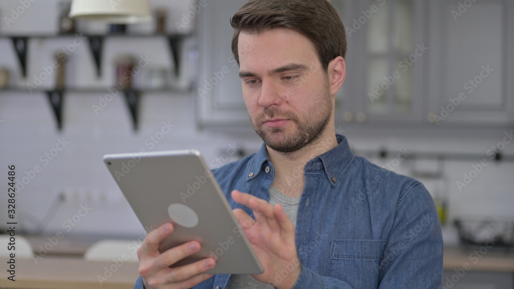 Portrait of Ambitious Beard Young Man using Tablet