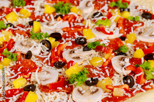 Raw pizza with mushroom, pepperoni and pineapple. Close up.