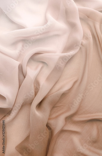 Silk fabric texture pastel beige color. Beautiful soft crumpled silk wedding background.Copy space