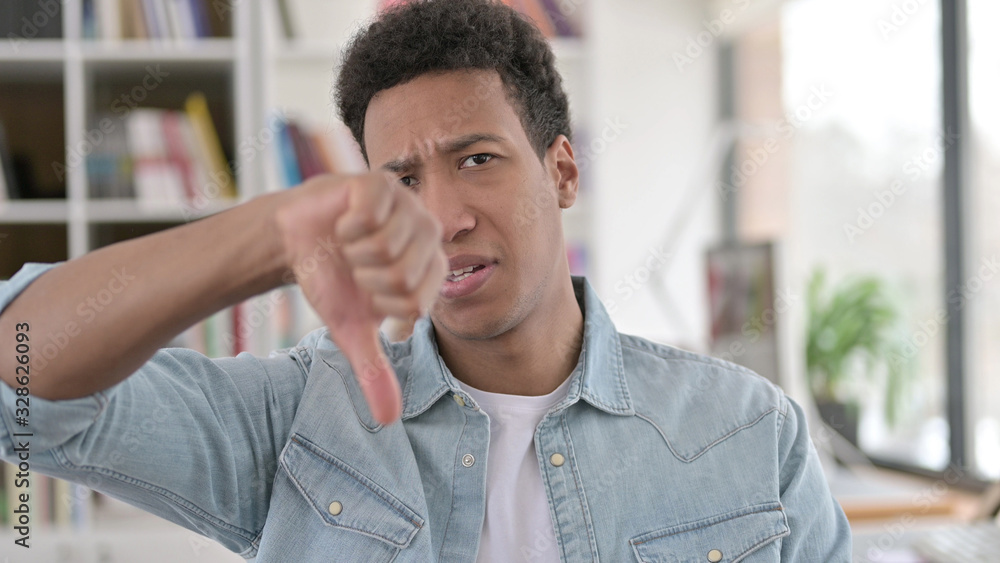Thumbs Down by Disappointed Young African American Man Thumbs Down by Disappointed Young African American Man