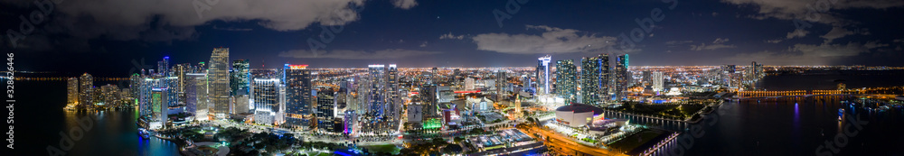 Amazing aerial panorama of Downtown Miami FL USA at night with bright city lights