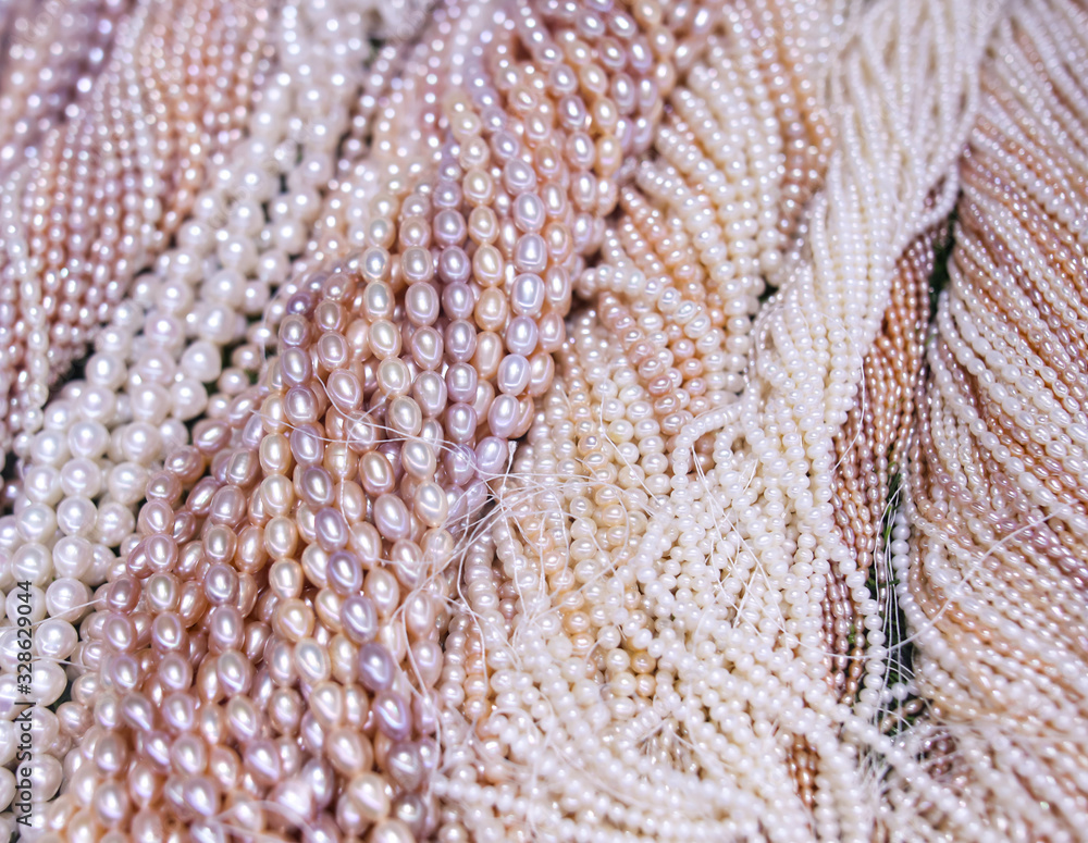 Pearl beads on a pink counter Pearl beads on a pink counter