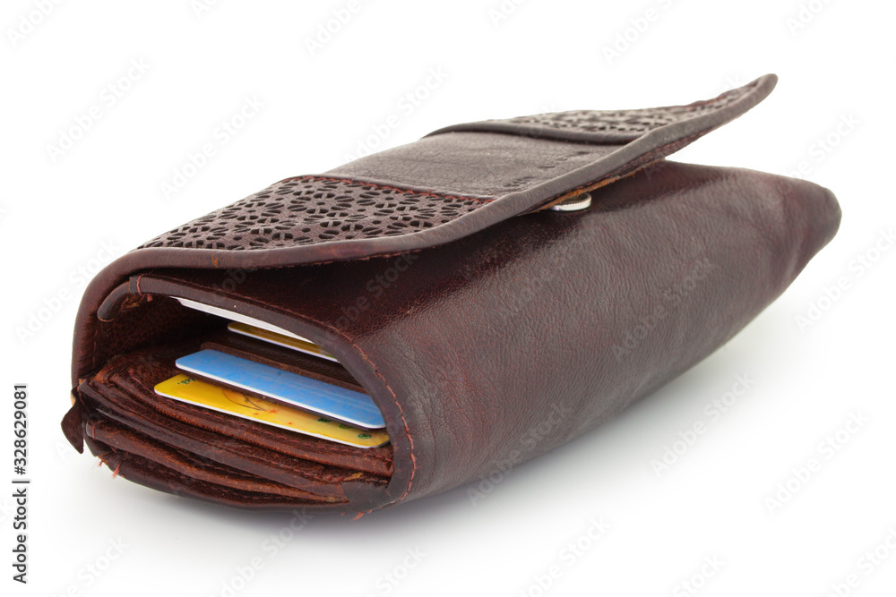 Typical closed female wallet full of cards, pictures, books of receipts and other things. Isolated on white background with natural shadow. Leather purseful on white bg. Brown skin. Female wallet. Typical closed female wallet full of cards, pictures, books of receipts and other things. Isolated on white background with natural shadow. Leather purseful on white bg. Brown skin. Female wallet.