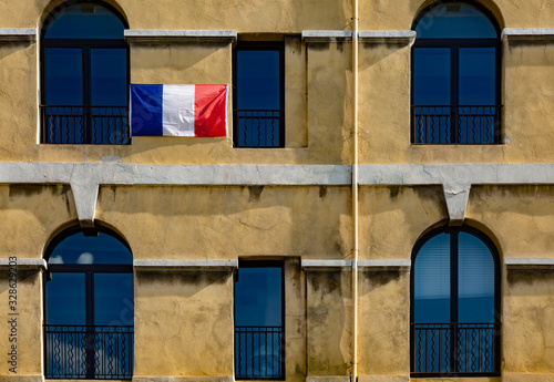 French flag on a building facade in Marseille