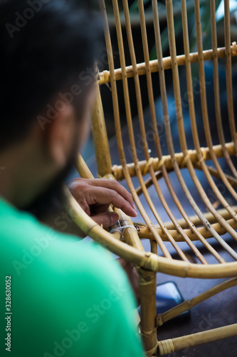 Restoration of rattan chair with white thread. Recycling, upcycling and from trash to reasure concept. Reuse for the environment.