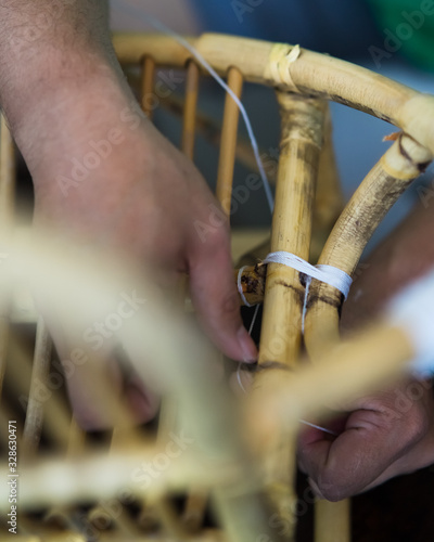 Restoration of rattan chair with white thread. Recycling, upcycling and from trash to reasure concept. Reuse for the environment. photo