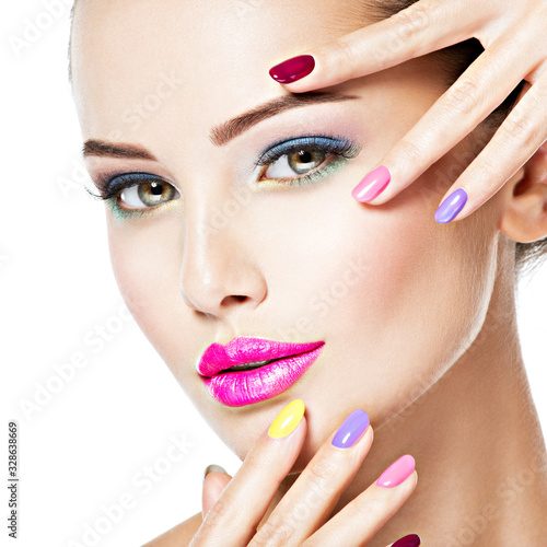 beautiful woman  with multicolor nails and fashion makeup