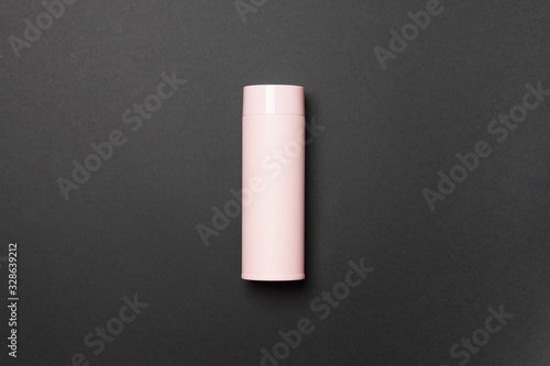 pink thermos cup on black background