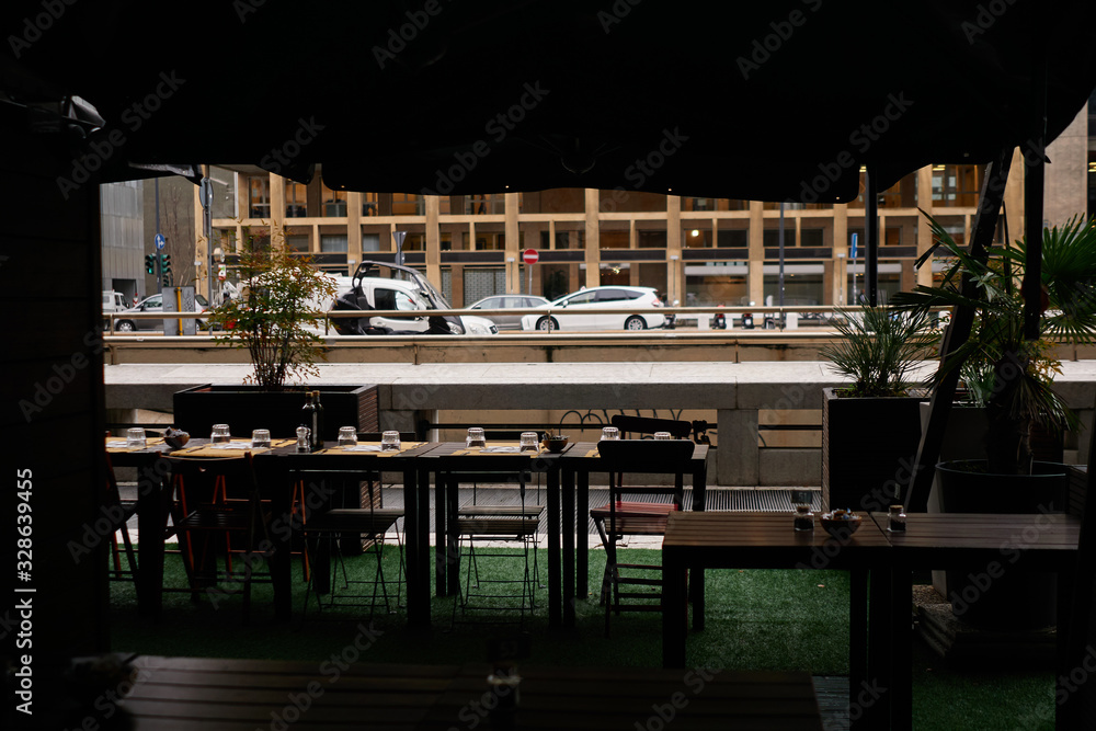 Fototapeta premium Served table in cafe with view to big city street with cars and buildings