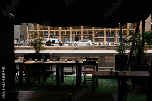 Served table in cafe with view to big city street with cars and buildings