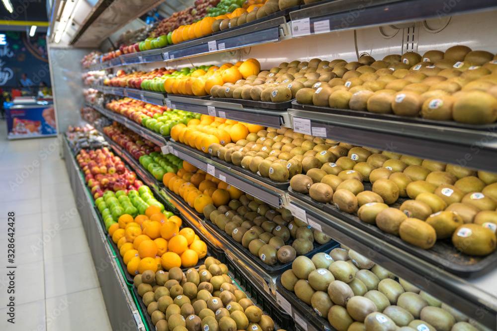 Fresh healthy fruits on shelves in supermarket