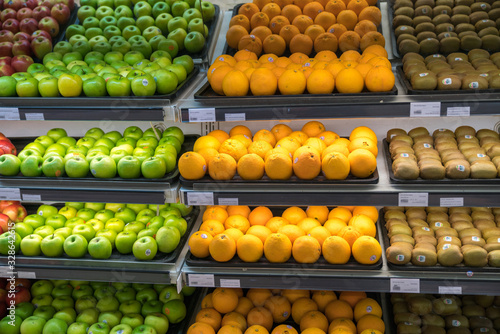 Fresh healthy fruits on shelves in supermarket
