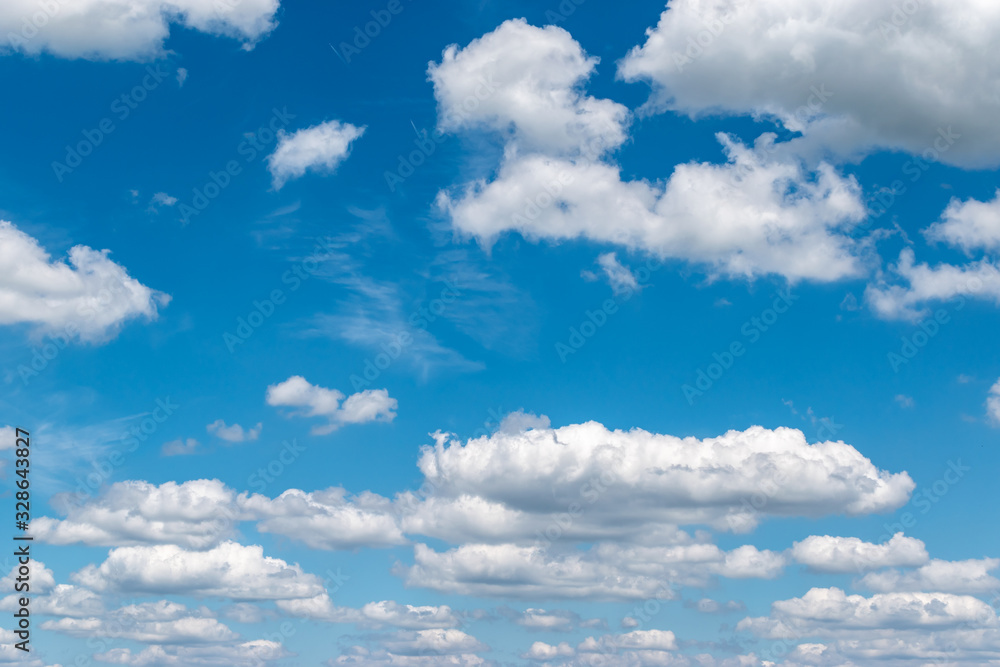 Fototapeta premium Floating white clouds on a blue sky background in summer.