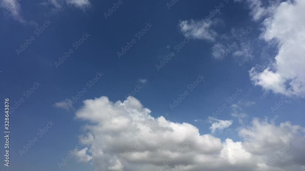 Time lapse blue sky white clouds,The sky and clouds moving in the hot summer sun Time lapse blue sky white clouds,The sky and clouds moving in the hot summer sun