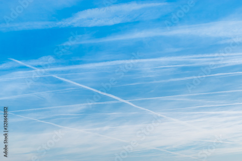 Blue sky and clouds with tracks of airplane backgrounds.