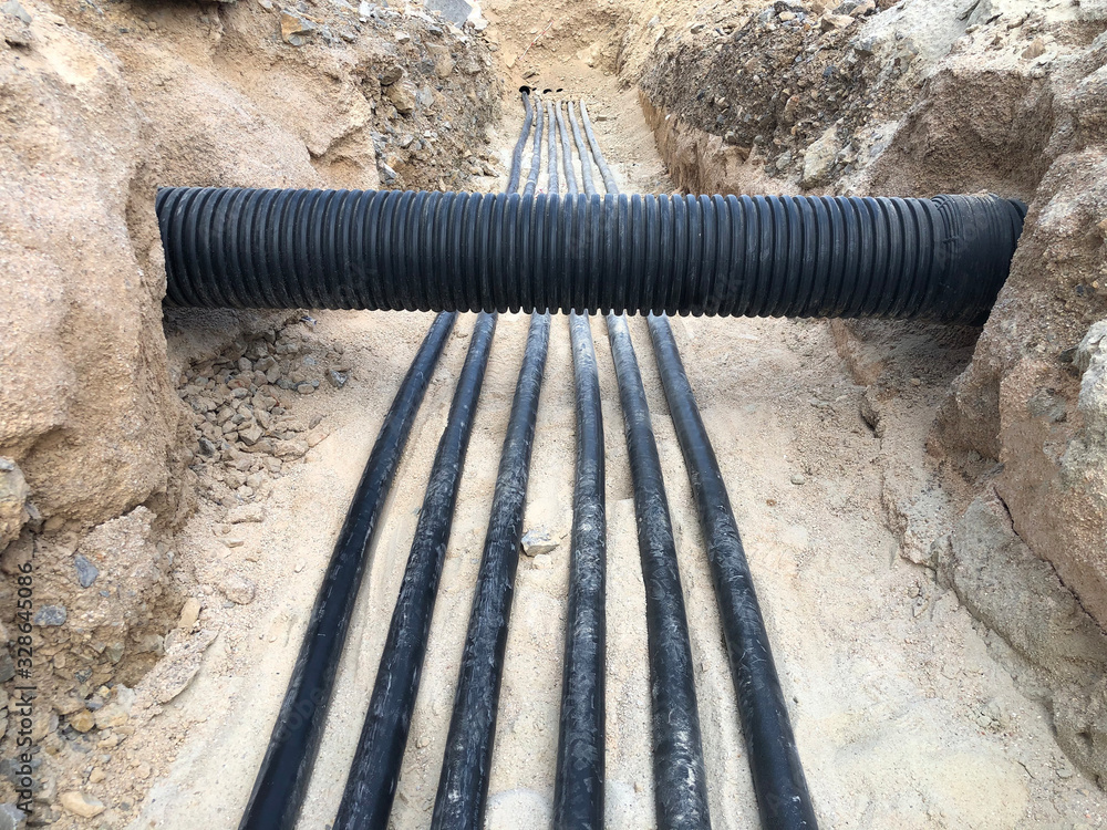 The high voltage electrical cable is laid in a trench Stock Photo