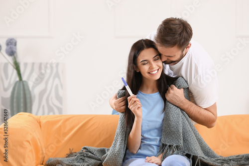 Happy young couple with pre...