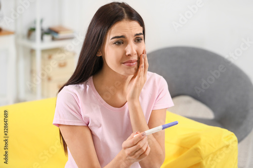 Sad young woman with pregna...