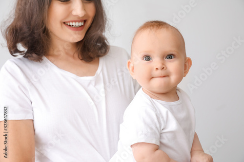 Cute baby with mother on li...