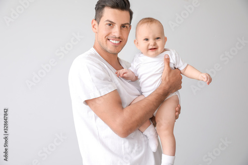Cute baby with father on li...