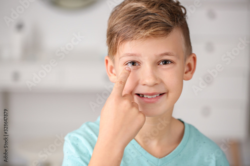 Little boy putting in conta...