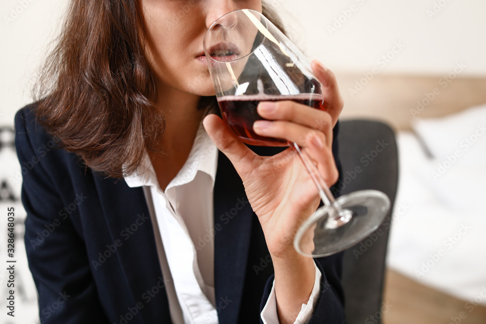 Woman drinking wine at home. Concept of alcoholism Woman drinking wine at home. Concept of alcoholism