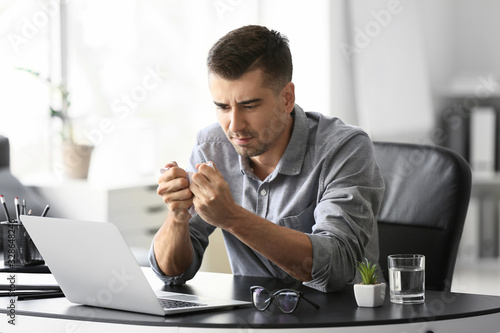 Depressed young businessman in office