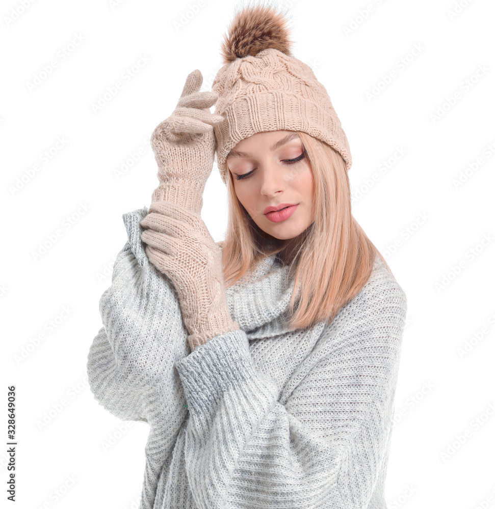 Young woman in warm sweater, hat and gloves on white background Young woman in warm sweater, hat and gloves on white background