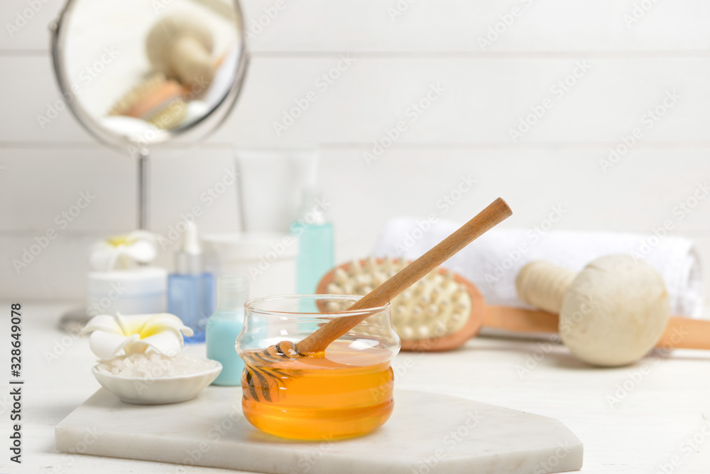 Jar with honey and spa items on table Jar with honey and spa items on table