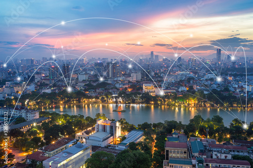 Fototapeta Naklejka Na Ścianę i Meble -  Smart city and wireless communication network concept. Digital network connection lines of Hanoi city at Hoan Kiem lake or Ho Guom