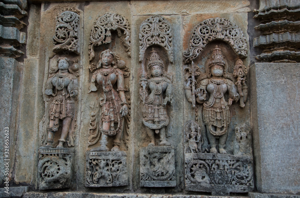 Carved idols on the outer wall of the Chennakeshava Temple complex, is a 12th-century Hindu temple dedicated to lord Vishnu, Belur, Karnataka, India
