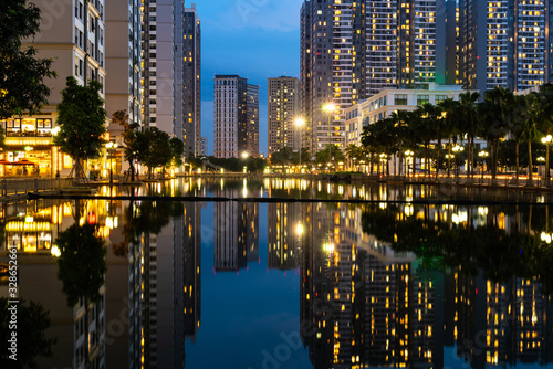 Twilight scene of modern city with buildings and reflection on lake in Hanoi  Vietnam