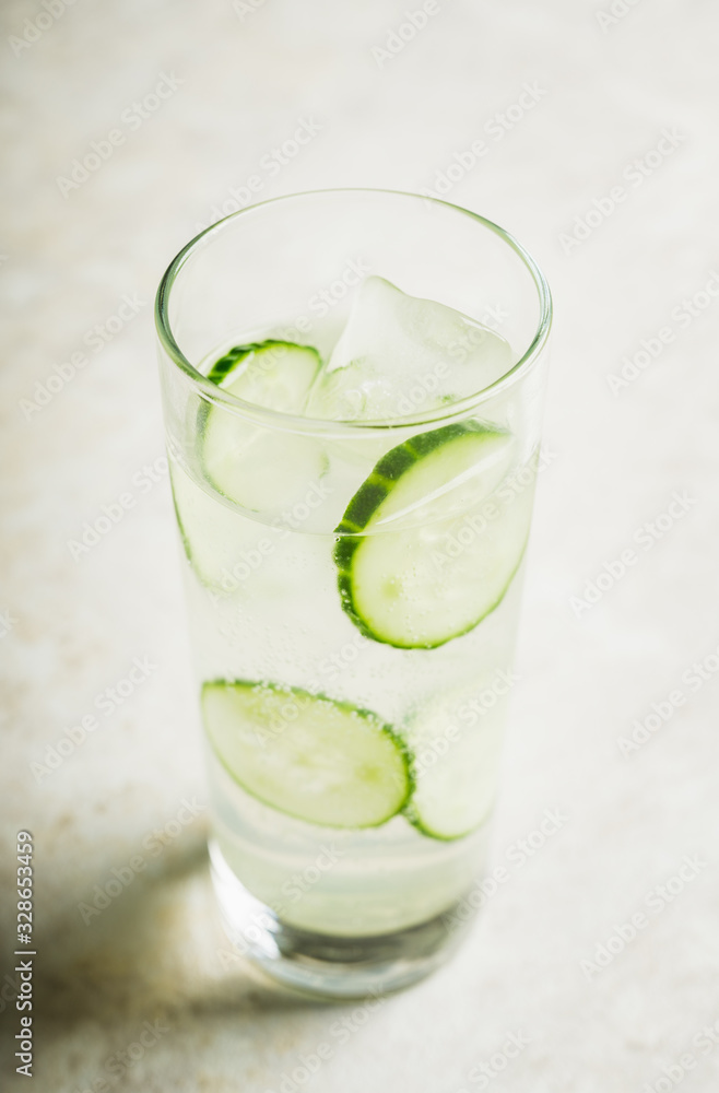 Detox beverage with cucumber slices on the rustic background. Selective focus. Shallow depth of field. Detox beverage with cucumber slices on the rustic background. Selective focus. Shallow depth of field.
