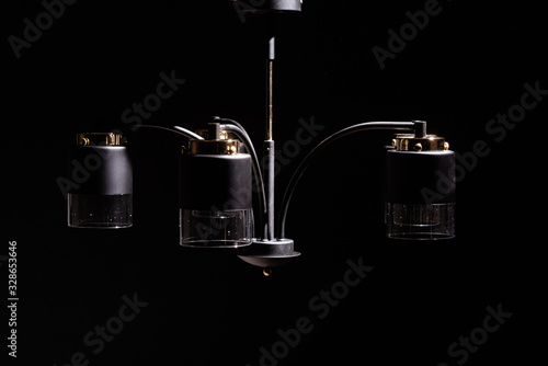 Fototapeta Naklejka Na Ścianę i Meble -  Modern lamp, chandelier on a black background. Lighting element of the interior. environmental materials of lamps