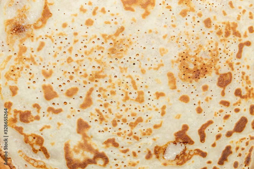 Fried pancakes. The texture of the dough. A treat on Shrove Tuesday. Culinary product. Fried pancakes. The texture of the dough. A treat on Shrove Tuesday. Culinary product.