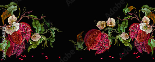 Ripened red pomegranate and white flowers. Banner. Autumn garden art. Fashion template for design, textile