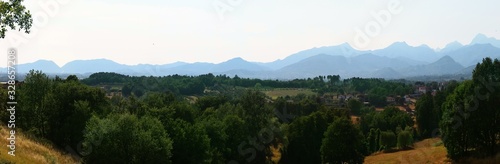 Panoramic view of Tuscan landscape with village, forest and mountains. Italy.